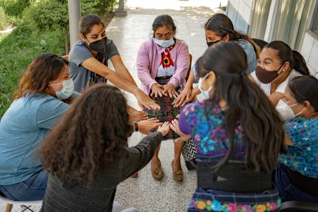 A group of people standing around each other