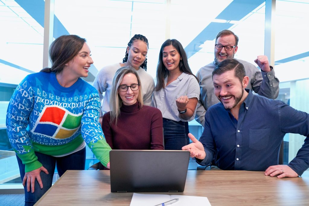 woman in maroon sweater using laptop