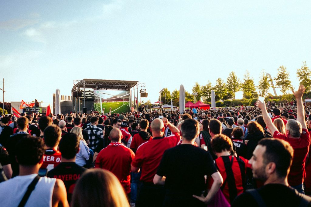 A large group of people standing in front of a stage